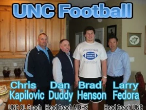 (L-R) UNC offensive line coach Chris Kapilovic, Monsignor Donovan head coach Dan Duddy, Brad Henson and UNC head coach Larry Fedora (L-R) UNC offensive line coach Chris Kapilovic, Monsignor Donovan head coach Dan Duddy, Brad Henson and UNC head coach Larry Fedora