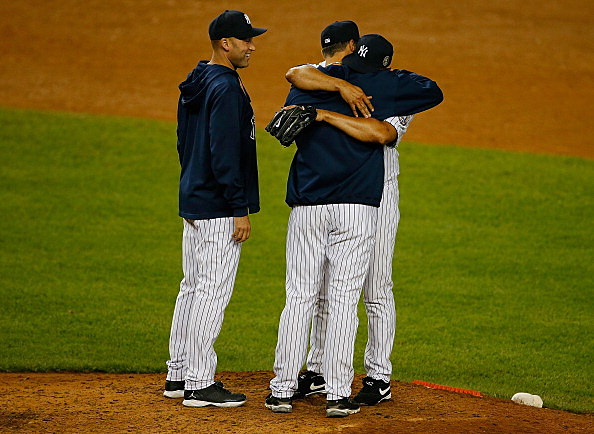 Mariano Rivera is hugged by Andy Pettitte #46 and Derek Jeter #2 as he is pulled the game against the Tampa Bay Rays at Yankee Stadium Mariano Rivera is hugged by Andy Pettitte #46 and Derek Jeter #2 as he is pulled the game against the Tampa Bay Rays at Yankee Stadium